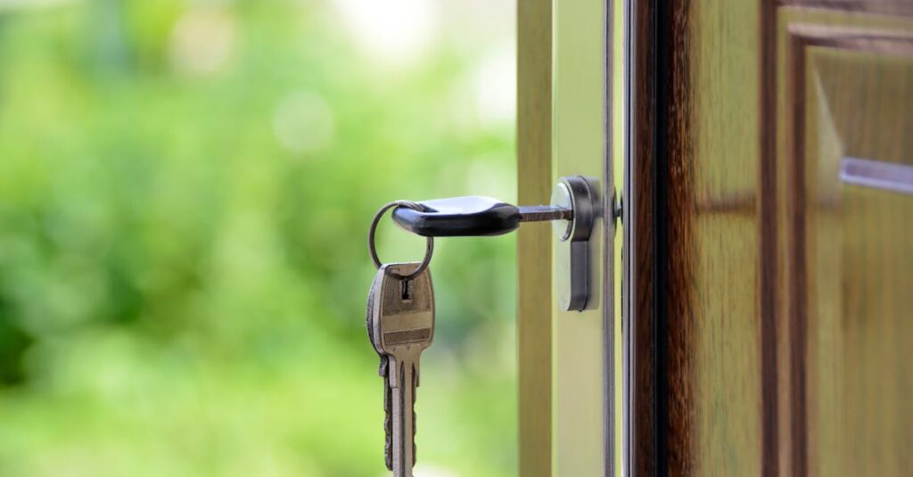 Key inserted in door lock against a blurred green background, symbolizing security and real estate.